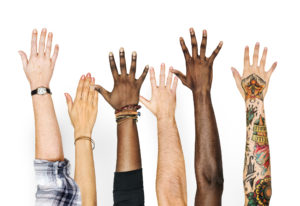 Diverse hands raised in the air - Ignite have signed up to the APSCo Diversity Commitment