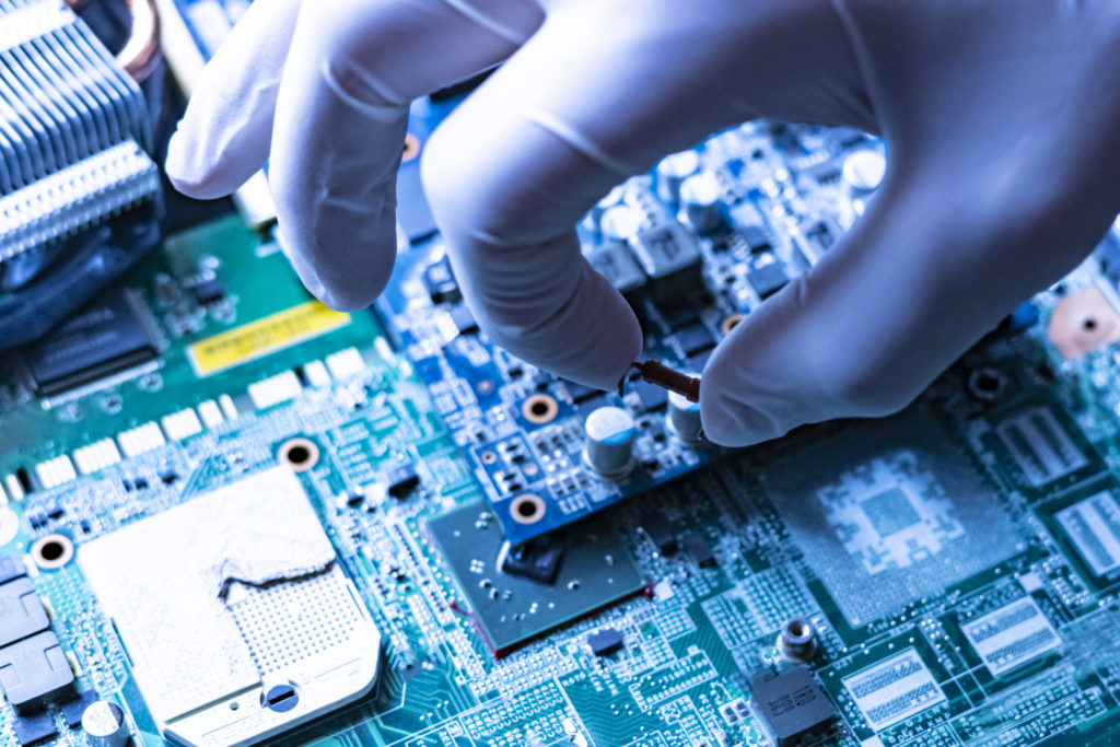 our year, A hand in a glove places a microchip on a chip board