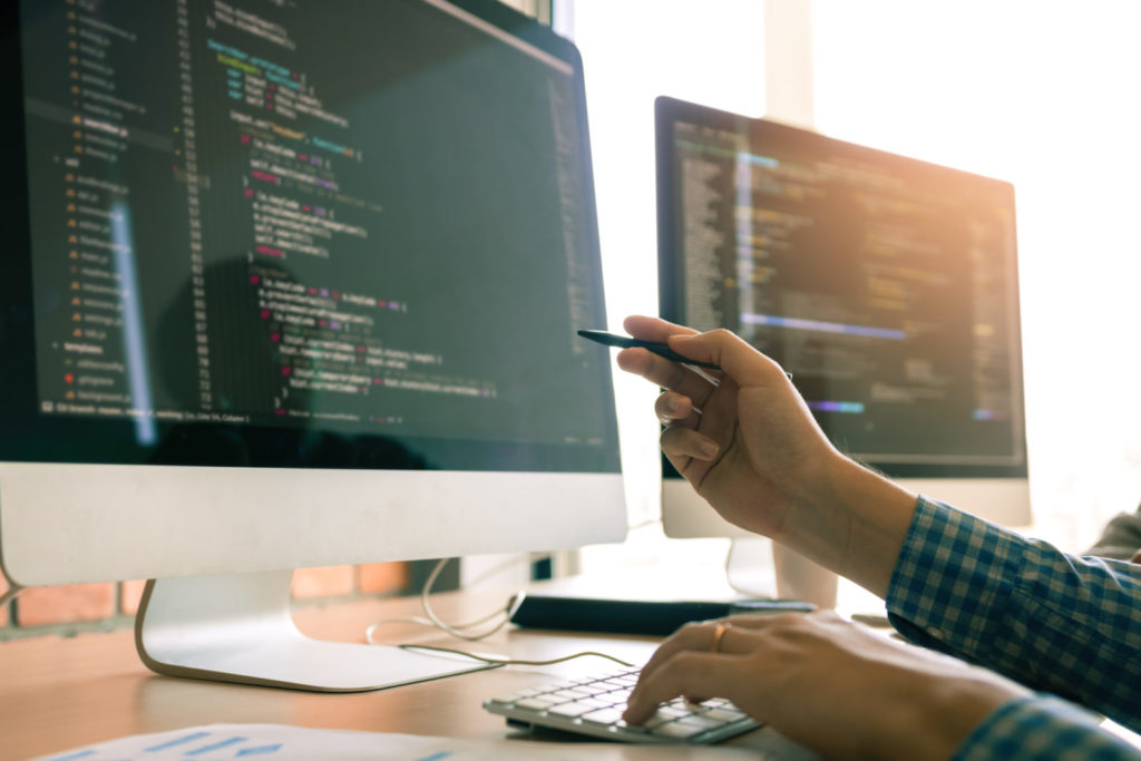 A person looks at a screen displaying code. The best programming languages allow for good careers in tech.