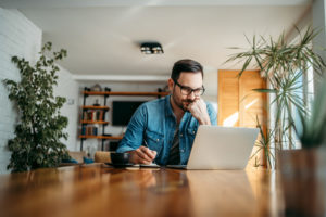 A man sits at his laptop working from home, our open-source tools help with working from home